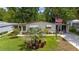 Inviting home with well-maintained lawn, garden, and an American flag displayed in a serene residential area at 514 Saint Andrews Blvd, Lady Lake, FL 32159