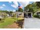 Charming single-story home featuring a well-manicured lawn, front porch, and an American flag displayed prominently at 514 Saint Andrews Blvd, Lady Lake, FL 32159