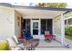 Charming front porch with seating, decorative wreath, and inviting entryway to the home at 514 Saint Andrews Blvd, Lady Lake, FL 32159