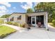Welcoming front porch with seating and a storm door, creating a cozy entrance to the home at 514 Saint Andrews Blvd, Lady Lake, FL 32159