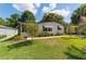 Charming residence featuring a well-manicured lawn, garden, and mature trees in a peaceful neighborhood setting at 514 Saint Andrews Blvd, Lady Lake, FL 32159