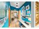 Hallway featuring a built-in desk, blue accent wall, decorative shelving, and access to bedrooms at 514 Saint Andrews Blvd, Lady Lake, FL 32159