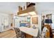 Open kitchen with white cabinets, blue lower cabinets, eat in bar, and modern appliances at 514 Saint Andrews Blvd, Lady Lake, FL 32159