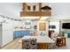 Bright eat-in kitchen featuring two-tone cabinets, tiled backsplash, and a breakfast nook with nautical themed chairs at 514 Saint Andrews Blvd, Lady Lake, FL 32159