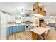 Bright kitchen featuring two-tone cabinets, tiled backsplash, and a breakfast nook with nautical themed chairs at 514 Saint Andrews Blvd, Lady Lake, FL 32159