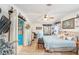 Bright bedroom featuring a ceiling fan, decorative accents, and a mirrored closet at 514 Saint Andrews Blvd, Lady Lake, FL 32159