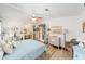 Bright bedroom with a ceiling fan, desk with vanity, and en-suite bathroom access at 514 Saint Andrews Blvd, Lady Lake, FL 32159