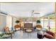Bright sunroom with tile flooring, comfortable seating, and lots of natural light at 514 Saint Andrews Blvd, Lady Lake, FL 32159