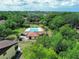 Aerial view of community pool surrounded by lush trees and landscaping at 519 Fairways Cir # A, Ocala, FL 34472