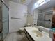 Traditional bathroom featuring a walk-in shower, tile flooring, and floral wallpaper at 519 Fairways Cir # A, Ocala, FL 34472