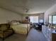 Comfortable bedroom area with natural light and a ceiling fan at 519 Fairways Cir # A, Ocala, FL 34472