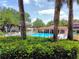 Community pool with clear blue water, surrounded by lush greenery, perfect for relaxation and recreation at 519 Fairways Cir # A, Ocala, FL 34472