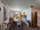 Inviting dining room featuring carpet, large windows, and an adjacent kitchen at 519 Fairways Cir # A, Ocala, FL 34472