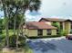 Charming condo exterior with lush tropical landscaping, convenient walkway, and dedicated guest parking spaces at 519 Fairways Cir # A, Ocala, FL 34472
