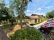 Well-landscaped condo exterior with mature trees and a guest parking area at 519 Fairways Cir # A, Ocala, FL 34472