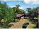 Exterior view of a building featuring lush landscaping, mature trees, and ample parking at 519 Fairways Cir # A, Ocala, FL 34472