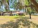 Condo exterior with well-maintained lawn and mature tree providing shade in a peaceful community setting at 519 Fairways Cir # A, Ocala, FL 34472