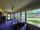Relaxing sunroom with great view, ceiling fan, and casual seating, ideal for enjoying the outdoors indoors at 519 Fairways Cir # A, Ocala, FL 34472