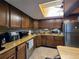 Well lit kitchen with stainless steel appliances and wood cabinets at 519 Fairways Cir # A, Ocala, FL 34472