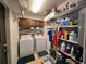Functional laundry area with washer, dryer, storage shelves, and wooden cabinets for efficient organization at 519 Fairways Cir # A, Ocala, FL 34472