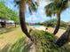 Community pool surrounded by tropical palm trees, lawn, and shrubs at 519 Fairways Cir # A, Ocala, FL 34472