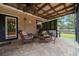 Charming covered back patio with wicker furniture, tiled floors, and string lighting at 530 Sw 35Th St, Ocala, FL 34471