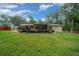 Lush backyard featuring a deck, well-maintained lawn, and mature trees, creating a serene outdoor space at 530 Sw 35Th St, Ocala, FL 34471