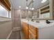 Modern bathroom with walk-in shower, double sinks, tiled floors, and ample lighting at 530 Sw 35Th St, Ocala, FL 34471