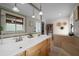 Well-lit bathroom featuring double sinks, soaking tub, tiled floors, and contemporary decor at 530 Sw 35Th St, Ocala, FL 34471
