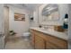 Bright bathroom with a single sink vanity, tile accents, and a framed beach print at 530 Sw 35Th St, Ocala, FL 34471