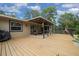 Spacious wooden deck featuring a covered seating area and a barbecue grill for outdoor entertaining at 530 Sw 35Th St, Ocala, FL 34471