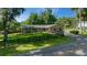 Charming single-story home with manicured lawn and a black fence, nestled amongst mature trees at 530 Sw 35Th St, Ocala, FL 34471