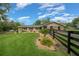 Charming single-story home featuring a lush lawn, landscaping, and a stylish black wooden fence in a serene setting at 530 Sw 35Th St, Ocala, FL 34471