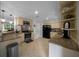 A well-lit kitchen features granite counters, tan cabinets, stainless appliances, and neutral tile flooring at 530 Sw 35Th St, Ocala, FL 34471