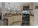 Kitchen with granite countertop, tan cabinets, stainless steel oven and microwave at 530 Sw 35Th St, Ocala, FL 34471