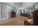 Inviting main bedroom with wood floors, ceiling fan, dresser, and reading chairs at 530 Sw 35Th St, Ocala, FL 34471