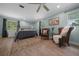 Spacious main bedroom with wood floors, neutral walls, ceiling fan, and large windows at 530 Sw 35Th St, Ocala, FL 34471