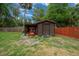 A backyard shed featuring double doors and attached lean-to with lawn equipment at 530 Sw 35Th St, Ocala, FL 34471
