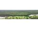 Scenic aerial view of a lush golf course community with wooded areas and lake at 546 Midway Dr # B, Ocala, FL 34472