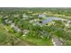 Aerial view of community homes nestled among mature trees and a beautiful lake at 546 Midway Dr # B, Ocala, FL 34472