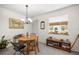 Cozy dining area with ample natural light, decorative chandelier, and views of green outdoors at 546 Midway Dr # B, Ocala, FL 34472