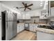 Bright kitchen featuring stainless steel appliances, white cabinets and granite countertops at 546 Midway Dr # B, Ocala, FL 34472