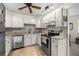 Well-lit kitchen with white cabinets, stainless steel appliances, and modern fixtures at 546 Midway Dr # B, Ocala, FL 34472