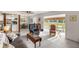 Inviting living room features neutral tones and seamless flow to sunroom and kitchen at 546 Midway Dr # B, Ocala, FL 34472