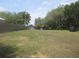 Expansive backyard view with trees, featuring a well-maintained lawn at 5949 Se 164Th Ct, Ocklawaha, FL 32179