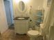 Elegant bathroom features a beautiful vanity with a black countertop and decorative oval mirror at 5949 Se 164Th Ct, Ocklawaha, FL 32179