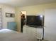 Bedroom features a spacious closet and a dresser with large television at 5949 Se 164Th Ct, Ocklawaha, FL 32179