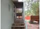 A covered patio with table, chairs and wooden railing at 5949 Se 164Th Ct, Ocklawaha, FL 32179
