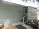 A rear exterior patio with lattice, and stairs at 5949 Se 164Th Ct, Ocklawaha, FL 32179