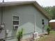 This side view of the home shows exterior air conditioning units at 5949 Se 164Th Ct, Ocklawaha, FL 32179
